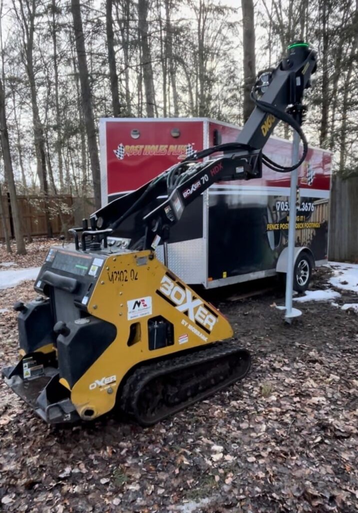 Technician mixing custom Portland cement and A gravel on-site with Post Holes Plus trailer for premium post installation quality.