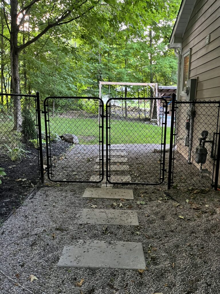 Fence construction underway in Bradford, Ontario with wood posts and panels being installed by Post Holes Plus.
