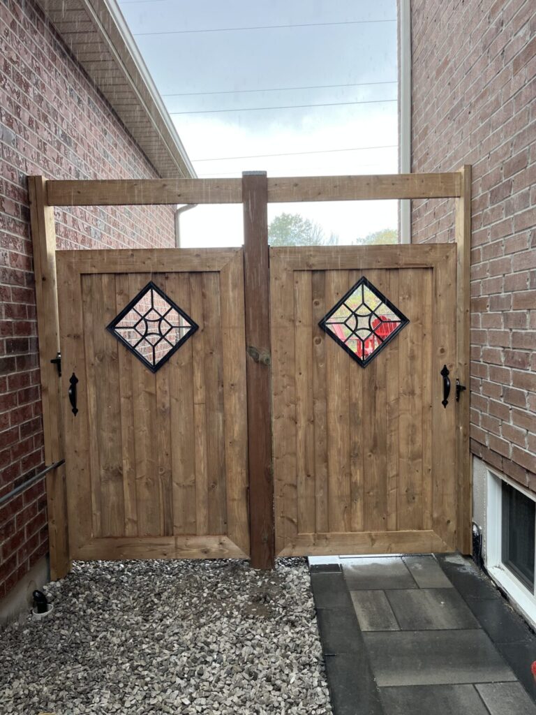 Wooden fence being built in Essa, Ontario with posts and panels installed by Post Holes Plus.