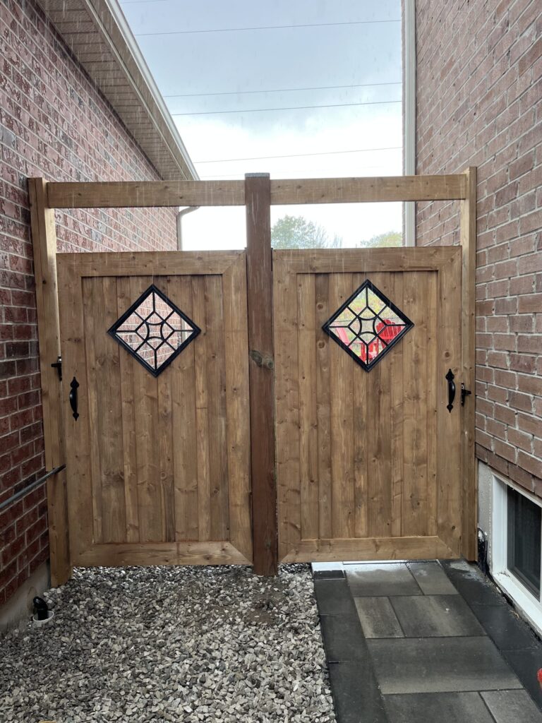 Fence being constructed by Post Holes Plus in a Springwater backyard with wooden posts and panels.