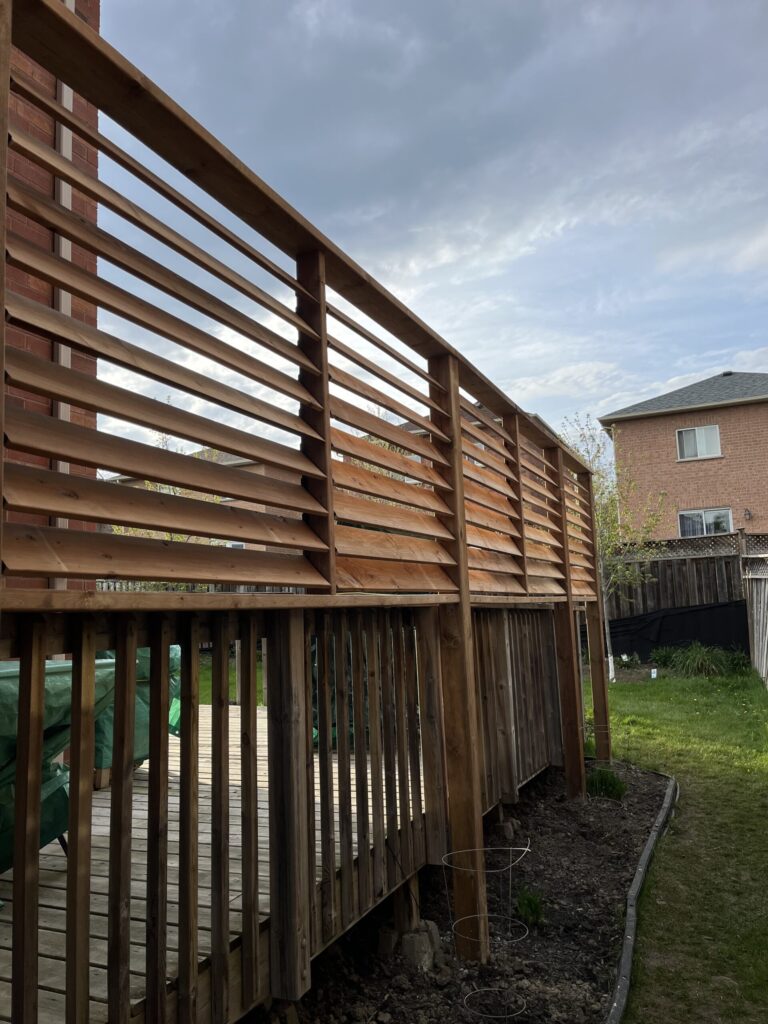 Post Holes Plus crew completing full fence construction with concrete footings in New Tecumseth.