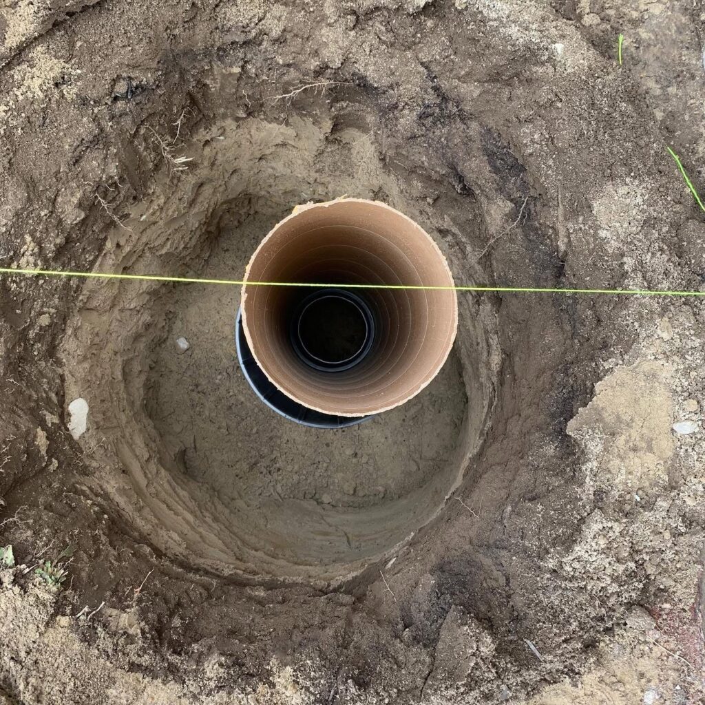 Concrete shed footings being installed by Post Holes Plus in a residential yard in Innisfil, Ontario