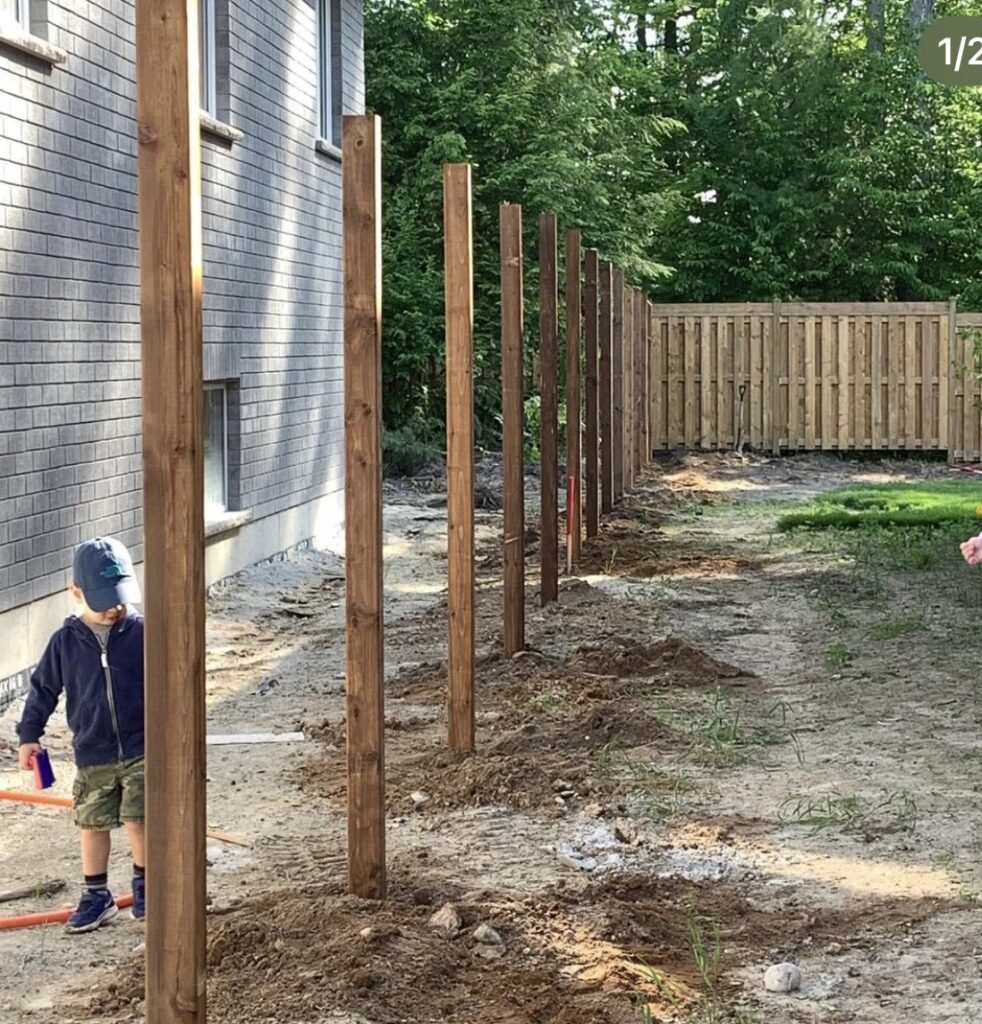 Fence post being set in concrete by Post Holes Plus on a residential property in Southern Ontario.